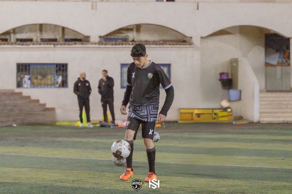 Young football players practicing basic skills